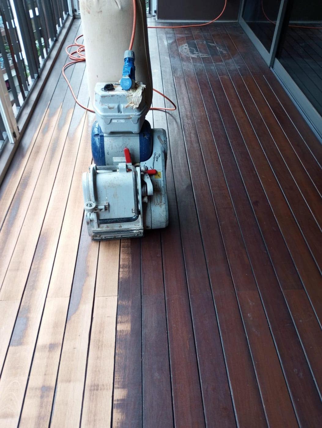 Drum sander restoring a timber deck