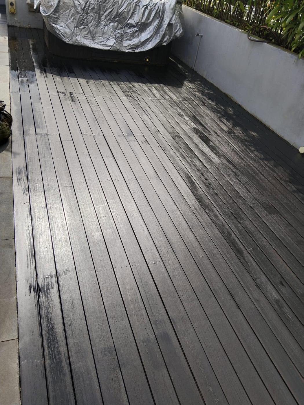 Stain being applied to a terrace deck