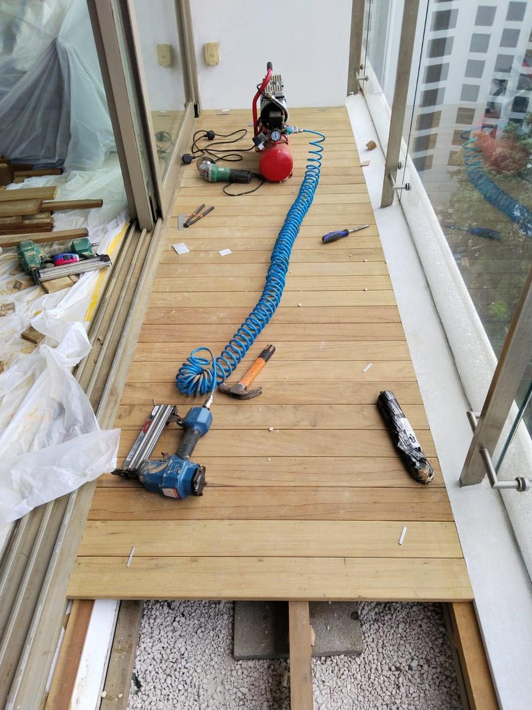 Timber deck planks being replaced on a balcony